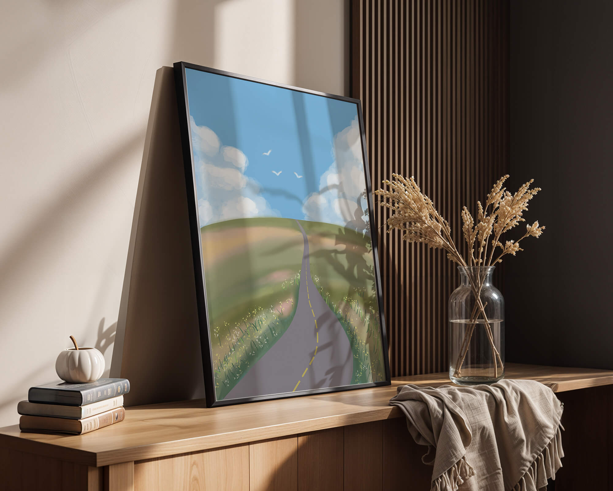 Sunlit Road Through Rolling Hills Under Blue Sky