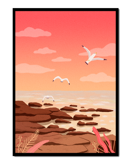 Seagulls flying over rocky coastline at sunset