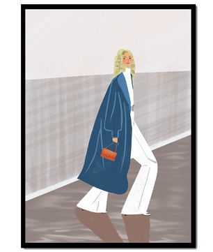 Fashionable Woman in Long Blue Coat Walking Along Corridor with Orange Handbag
