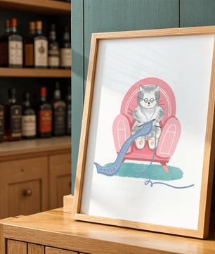 Cozy knitting cat relaxing in an armchair with a warm scarf - Mi tienda