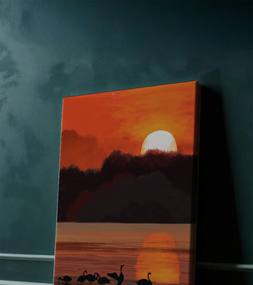 Serene sunset over a lake with silhouetted swans