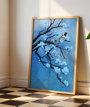 Bird on a branch with blue flowers against a snowy background