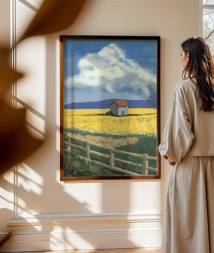 Idyllic rural scene with house and yellow field under blue sky