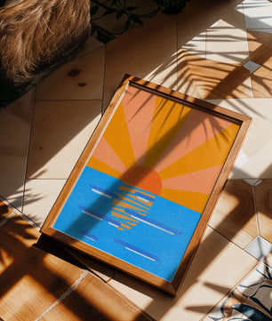 A vibrant sunrise illustration over the ocean with colorful rays