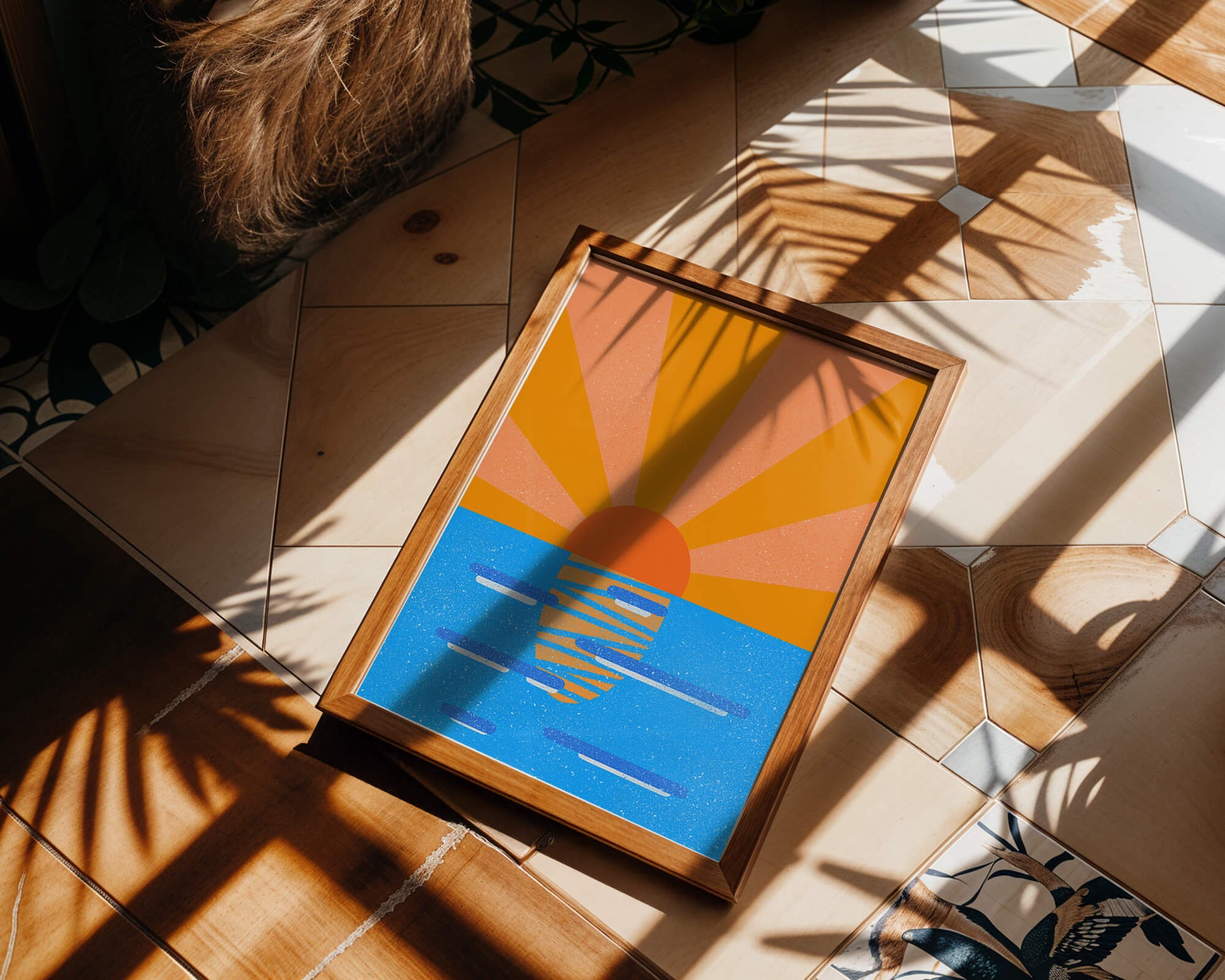A vibrant sunrise illustration over the ocean with colorful rays