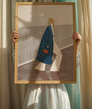 Fashionable Woman in Long Blue Coat Walking Along Corridor with Orange Handbag