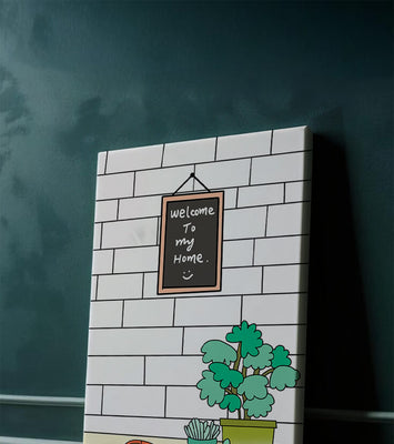 Chalkboard welcome sign with potted plants and a toy car