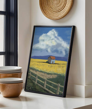 Idyllic rural scene with house and yellow field under blue sky