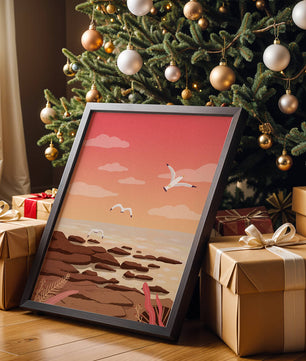 Seagulls flying over rocky coastline at sunset