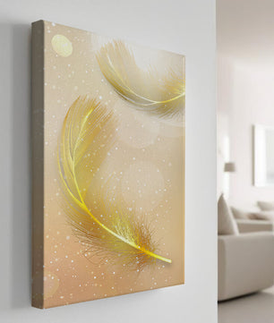 Elegant golden feathers with sparkling particles on soft background