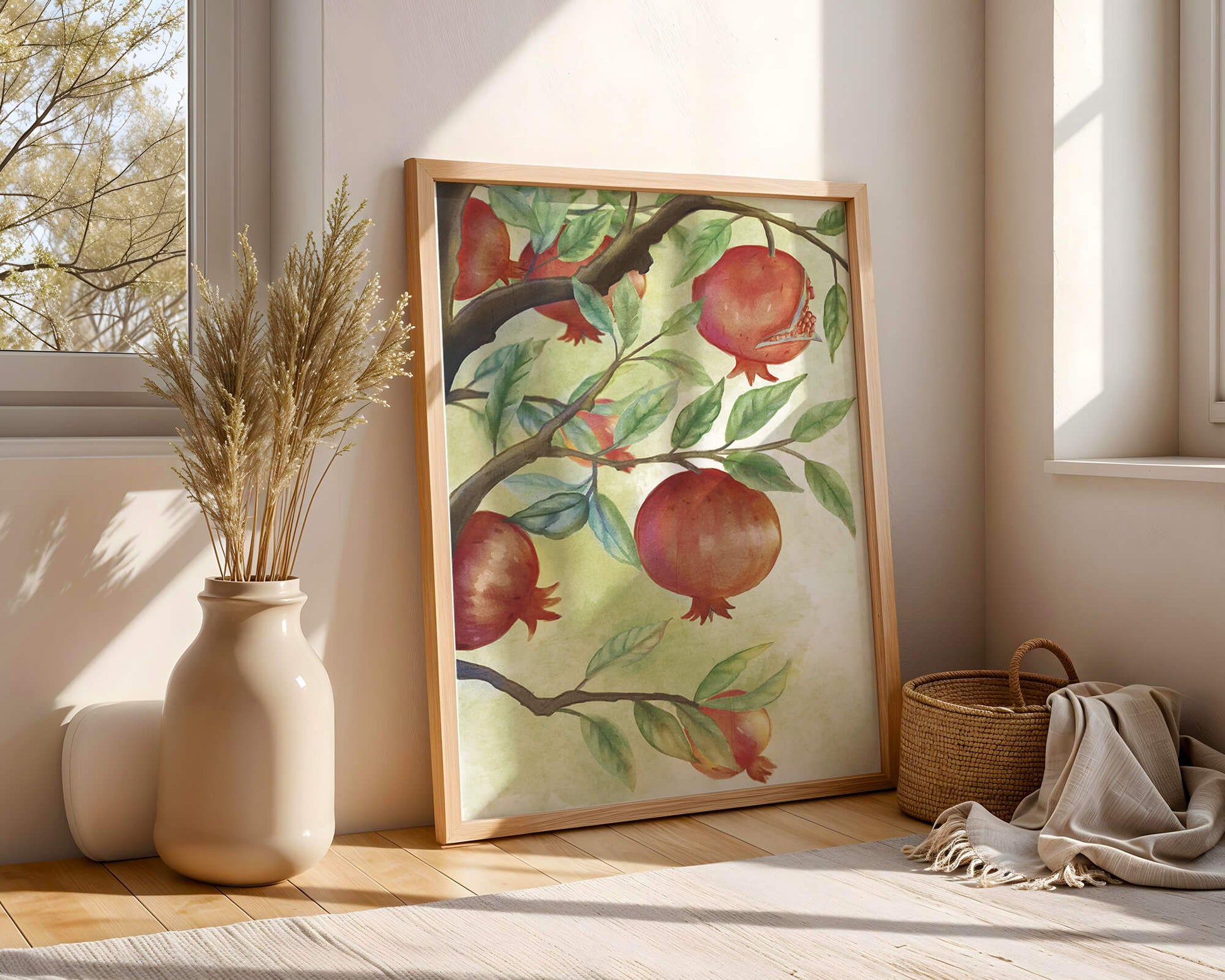 Watercolor illustration of pomegranates on a branch with leaves