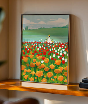 Woman with bicycle in vibrant tulip field by a lake