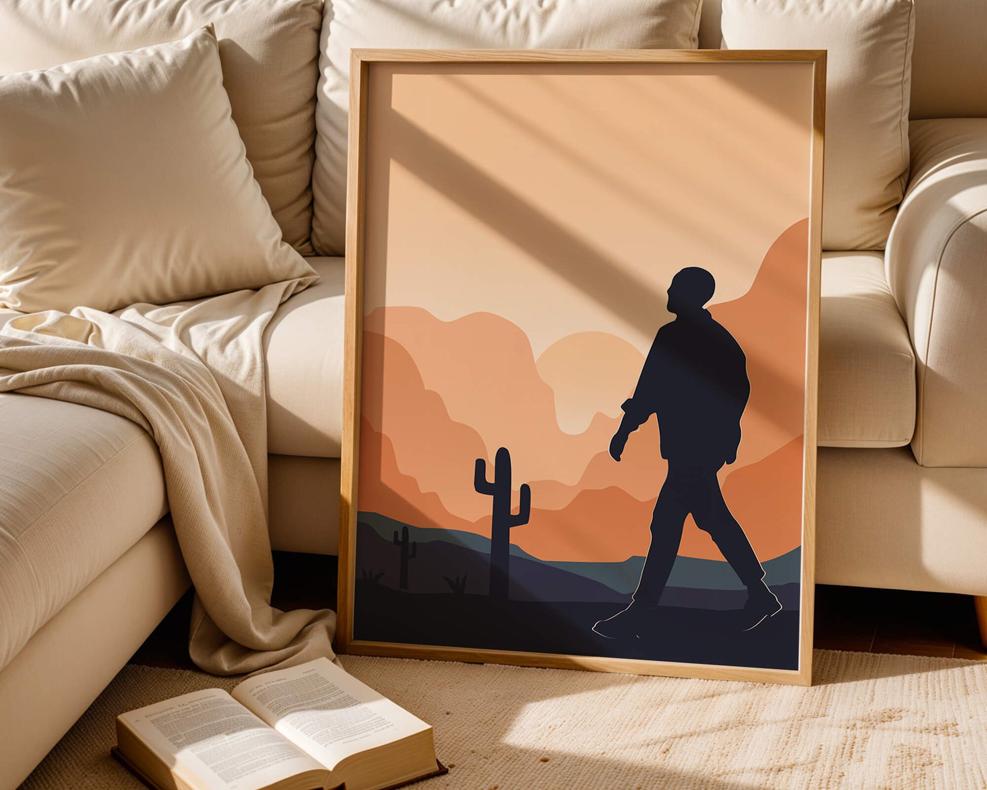 Silhouetted figure walking in desert landscape at sunset