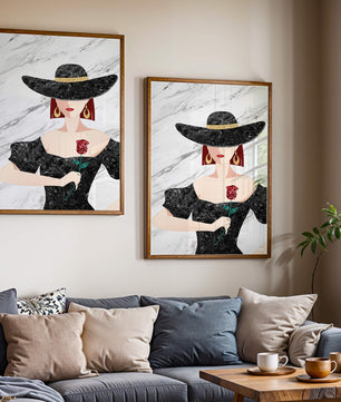 Elegant woman in wide-brimmed hat holding a rose on marble background