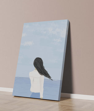 Woman gazing at the ocean with blue sky and clouds