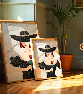 Elegant woman in wide-brimmed hat holding a rose on marble background