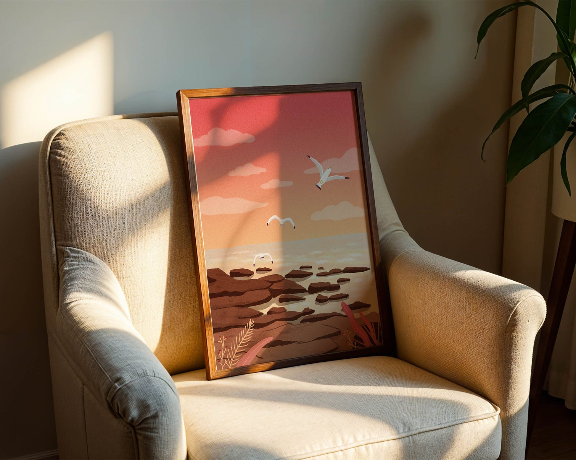 Seagulls flying over rocky coastline at sunset