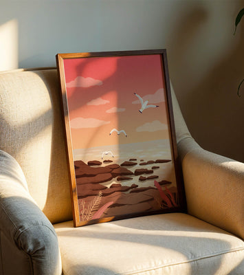 Seagulls flying over rocky coastline at sunset