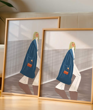 Fashionable Woman in Long Blue Coat Walking Along Corridor with Orange Handbag