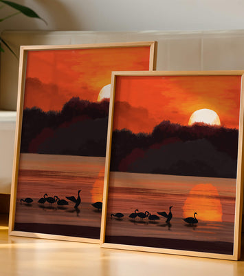 Serene sunset over a lake with silhouetted swans