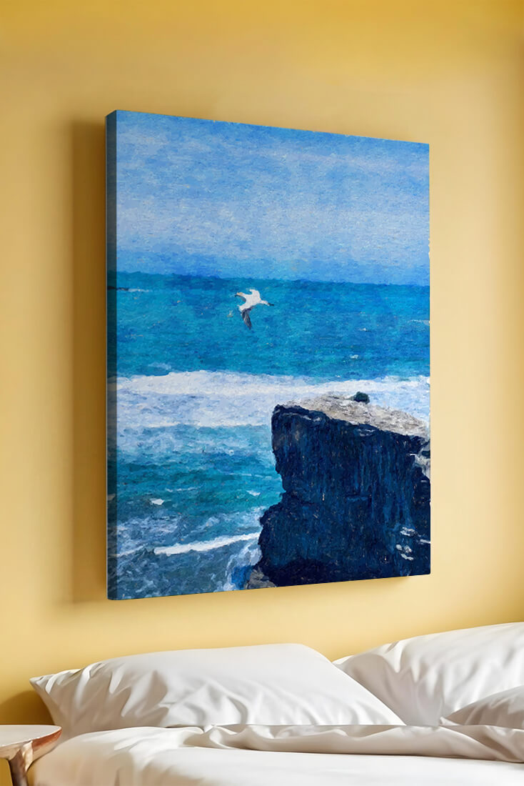 Seascape with soaring seagull over rocky cliff and ocean waves