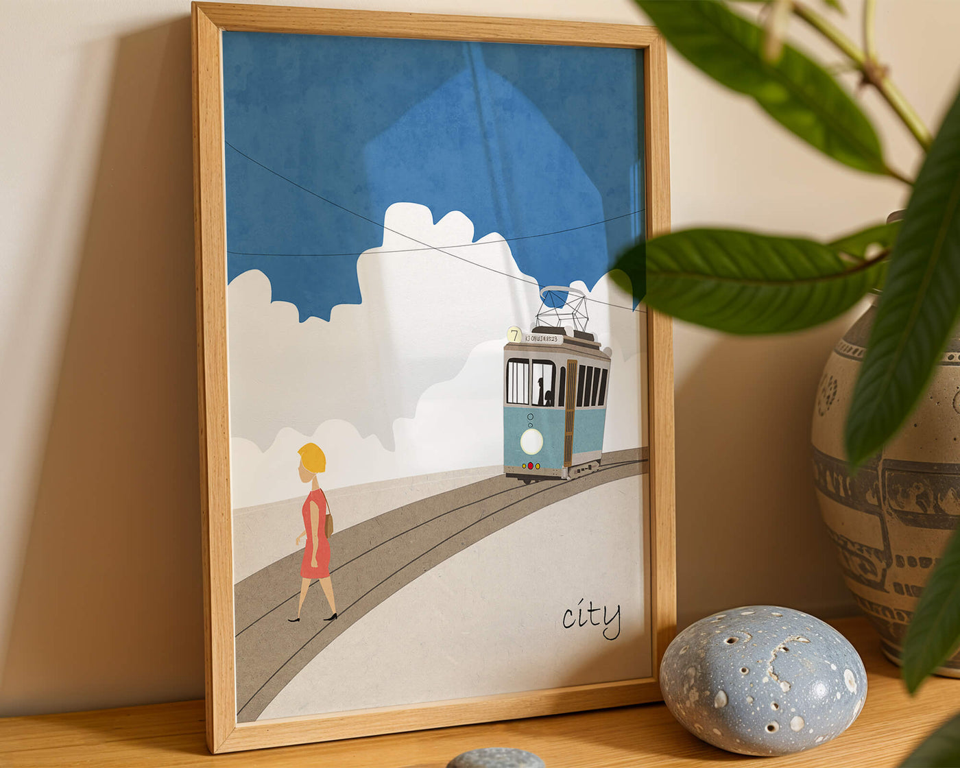 Urban scene with tram and pedestrian under a blue sky