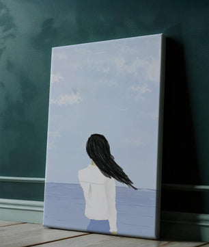 Woman gazing at the ocean with blue sky and clouds