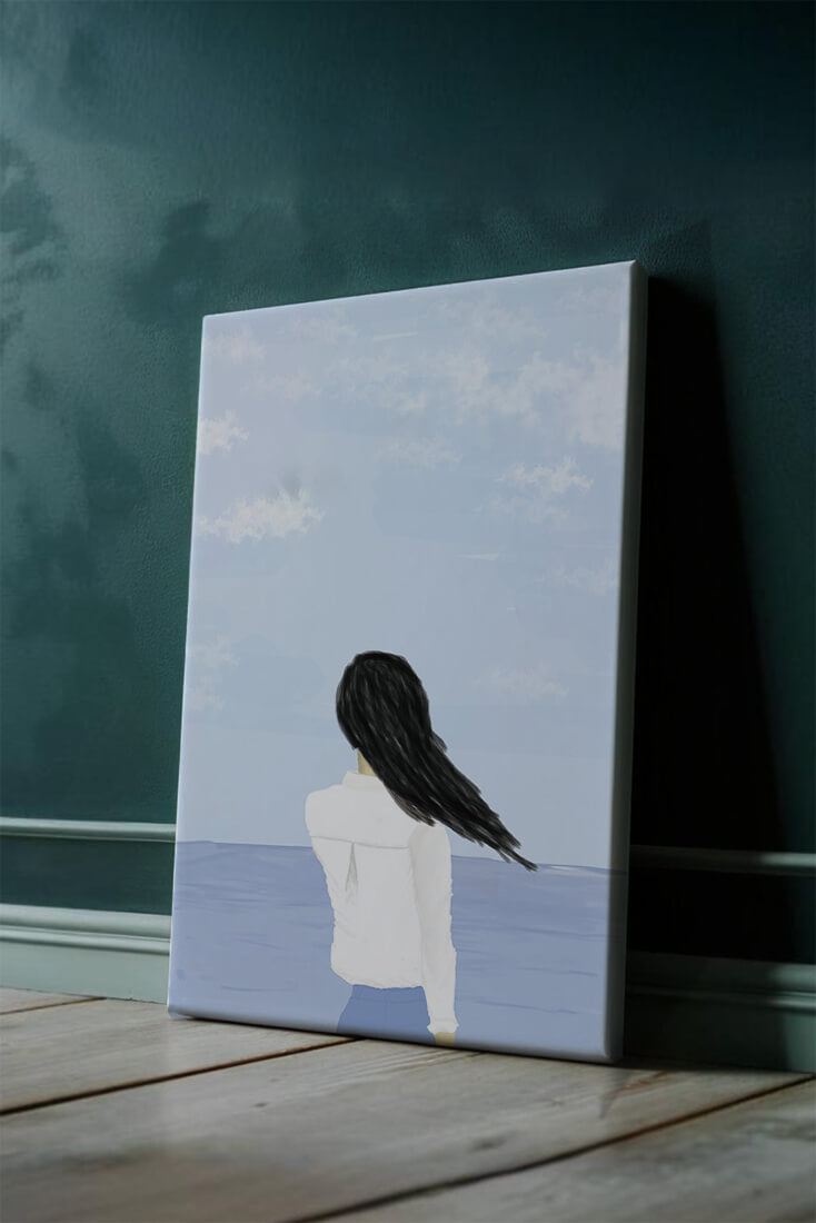 Woman gazing at the ocean with blue sky and clouds