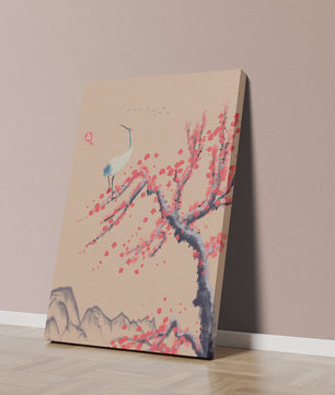 Elegant crane on cherry blossom tree with mountainous background