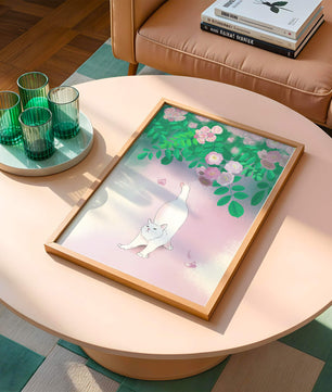 White cat stretching beneath blooming flowers in a pastel garden setting