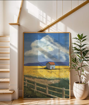 Idyllic rural scene with house and yellow field under blue sky