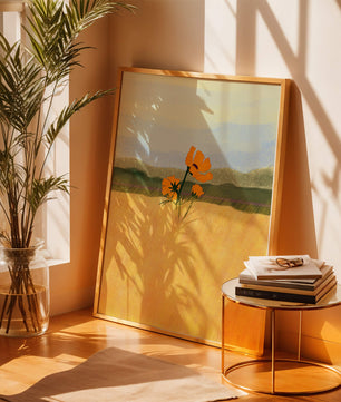 Orange Flowers in a Golden Field with Mountains and Blue Sky