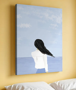 Woman gazing at the ocean with blue sky and clouds