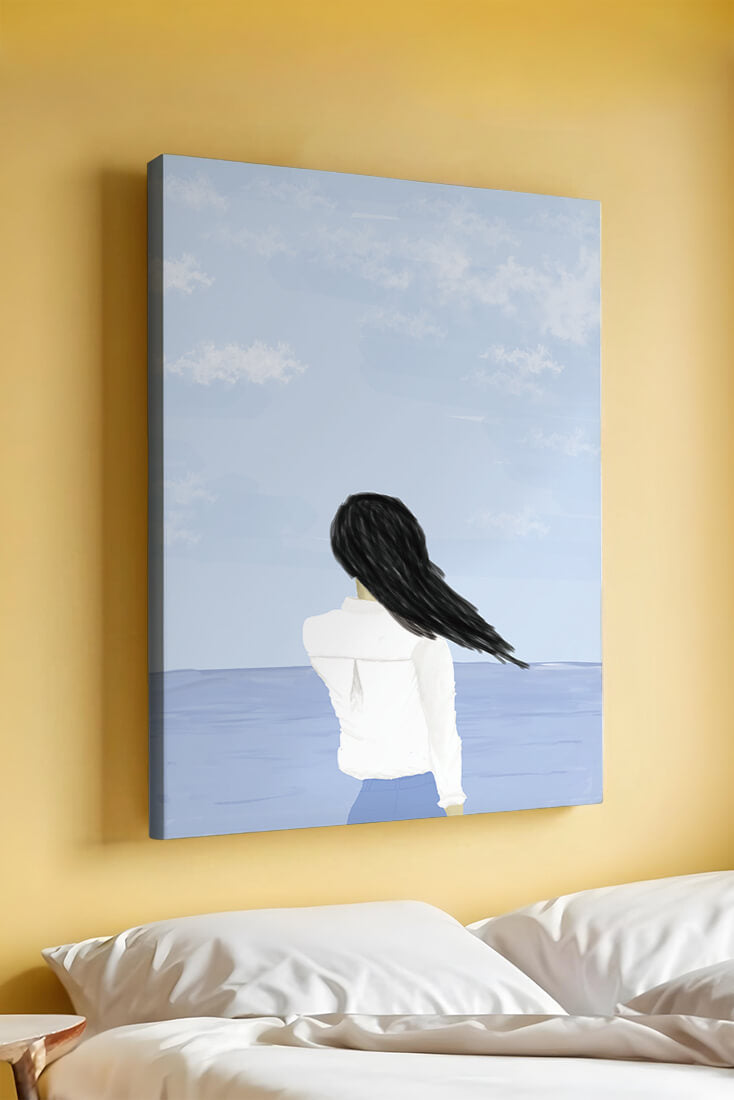 Woman gazing at the ocean with blue sky and clouds