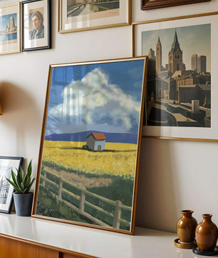 Idyllic rural scene with house and yellow field under blue sky