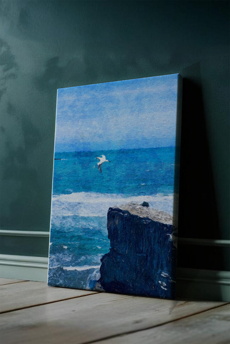 Seascape with soaring seagull over rocky cliff and ocean waves
