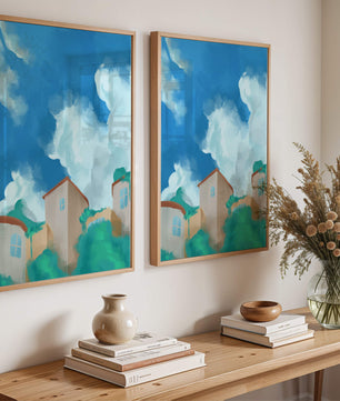 Serene landscape with houses and fluffy clouds against a blue sky