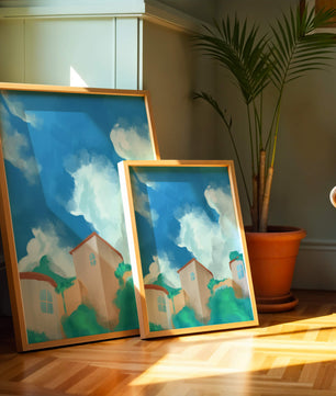 Serene landscape with houses and fluffy clouds against a blue sky