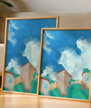 Serene landscape with houses and fluffy clouds against a blue sky
