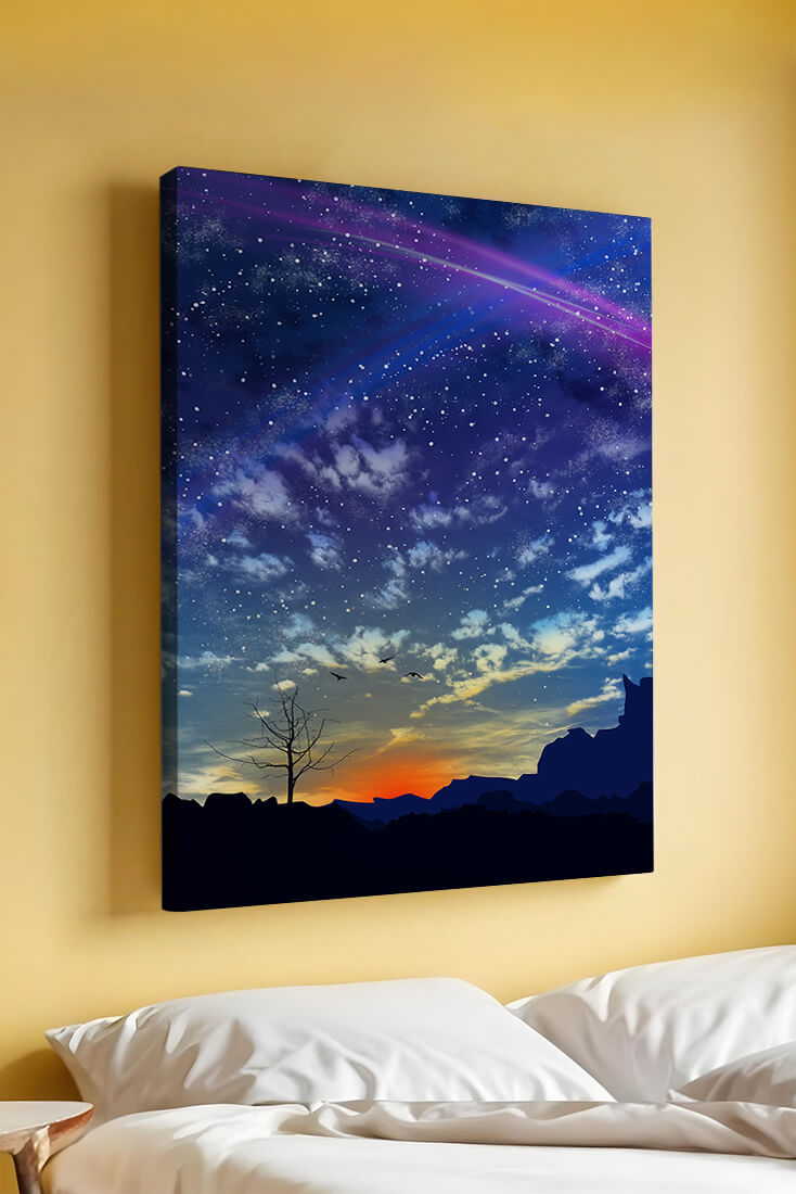 Starlit night sky with colorful sunset and silhouetted landscape