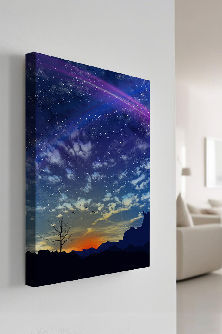 Starlit night sky with colorful sunset and silhouetted landscape