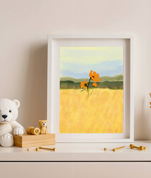 Orange Flowers in a Golden Field with Mountains and Blue Sky