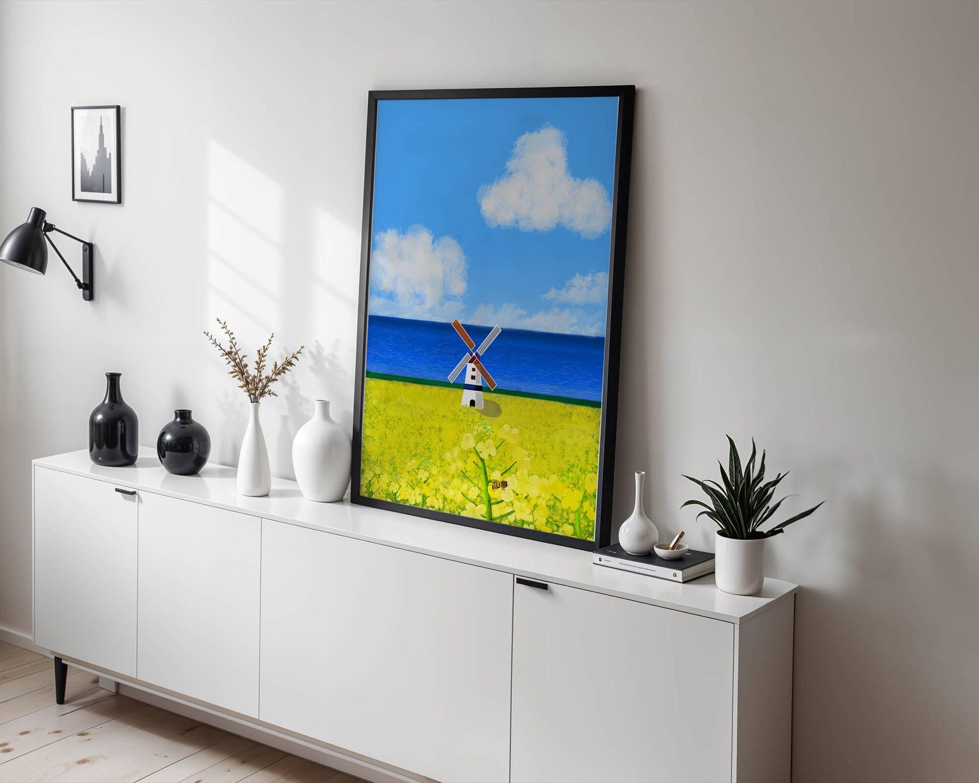Scenic landscape with windmill in blooming field by the sea