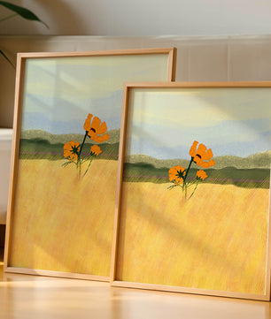 Orange Flowers in a Golden Field with Mountains and Blue Sky