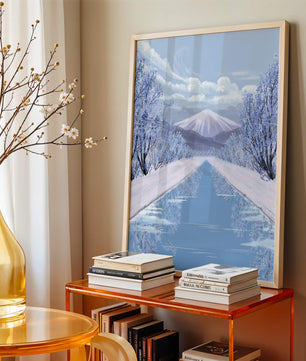 Serene winter landscape with mountain and snowy trees reflecting in water