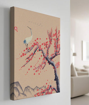 Elegant crane on cherry blossom tree with mountainous background