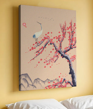 Elegant crane on cherry blossom tree with mountainous background