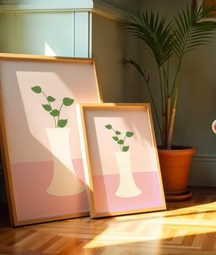 Simple Minimalist Illustration of a White Vase with Green Leaves on a Pink Background - Mi tienda