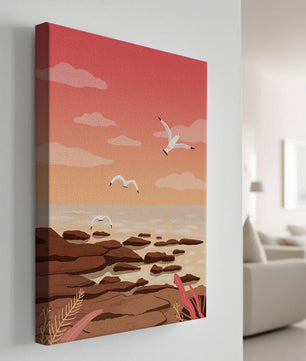 Seagulls flying over rocky coastline at sunset