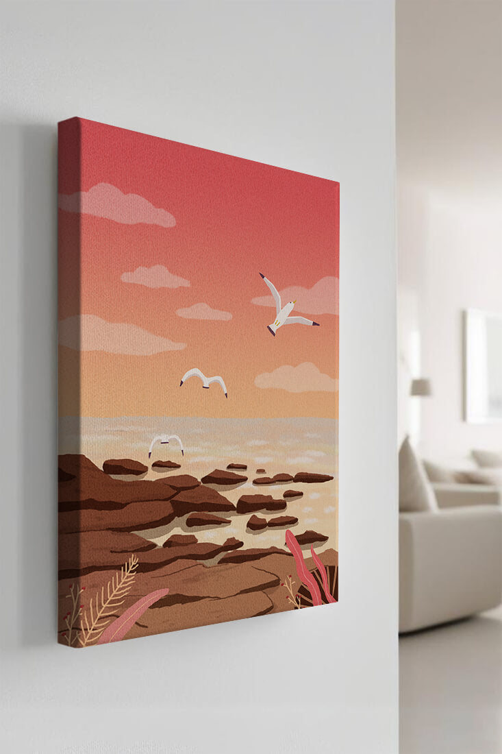 Seagulls flying over rocky coastline at sunset